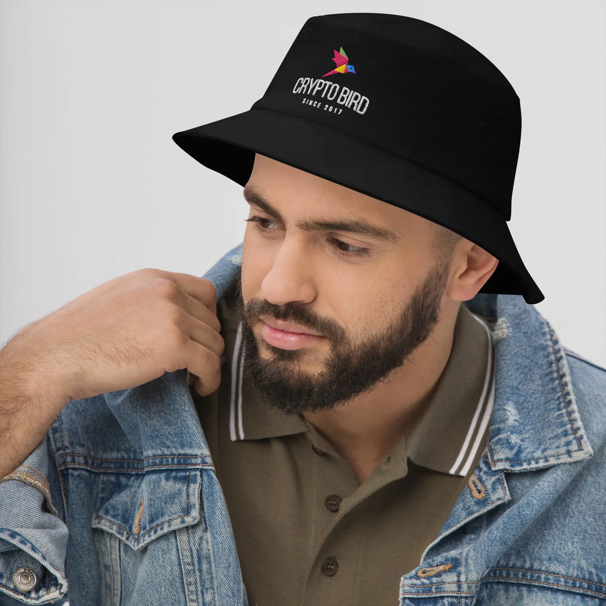 Crypto Bird Bucket hat in black, worn, angled from the left